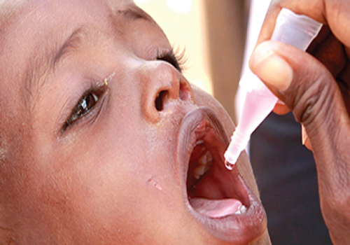 A child taking oral polio vaccine