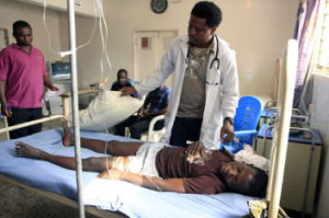 A doctor attending to a patient in a hospital Source Google 300x199